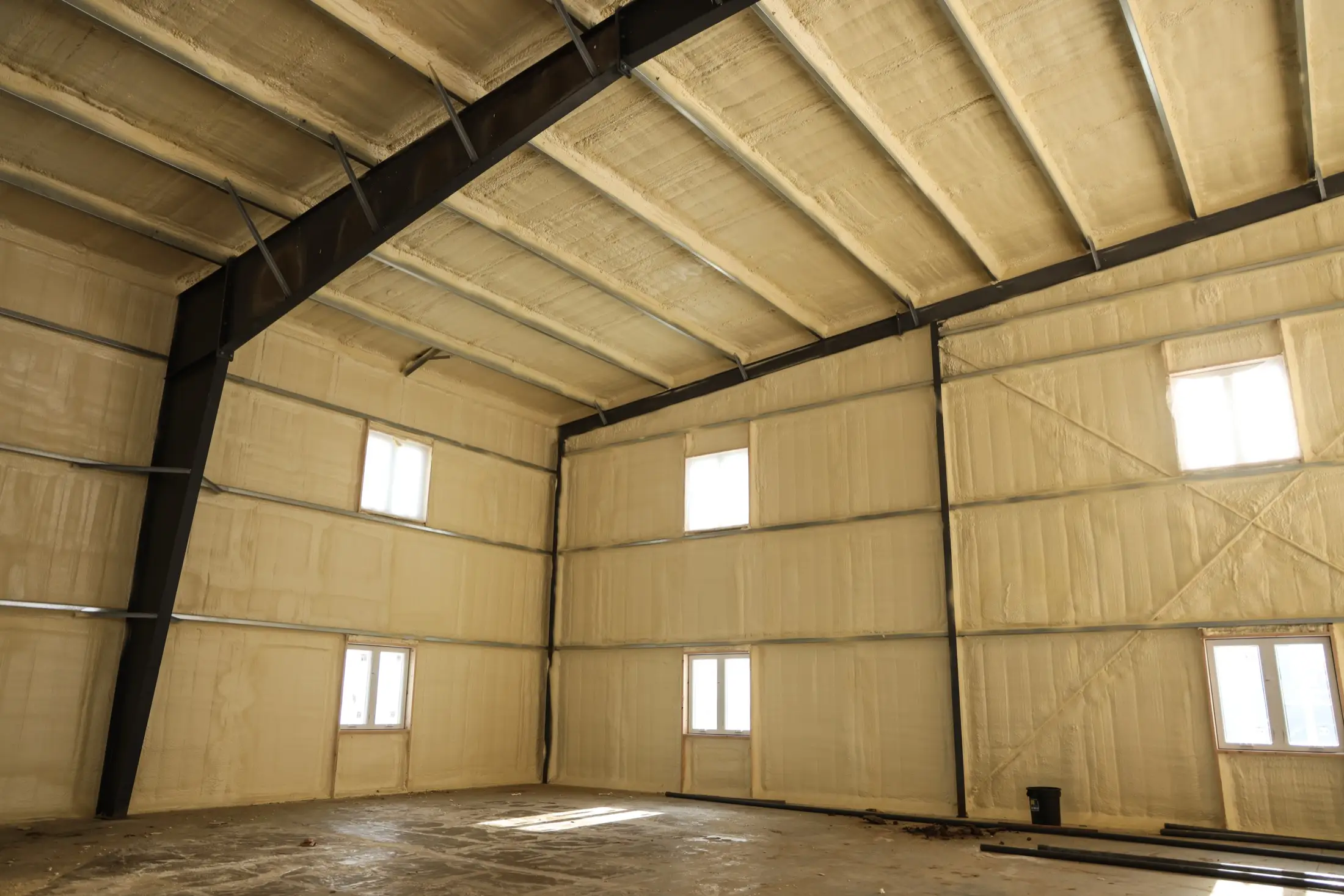 Wall cavity spray foam application